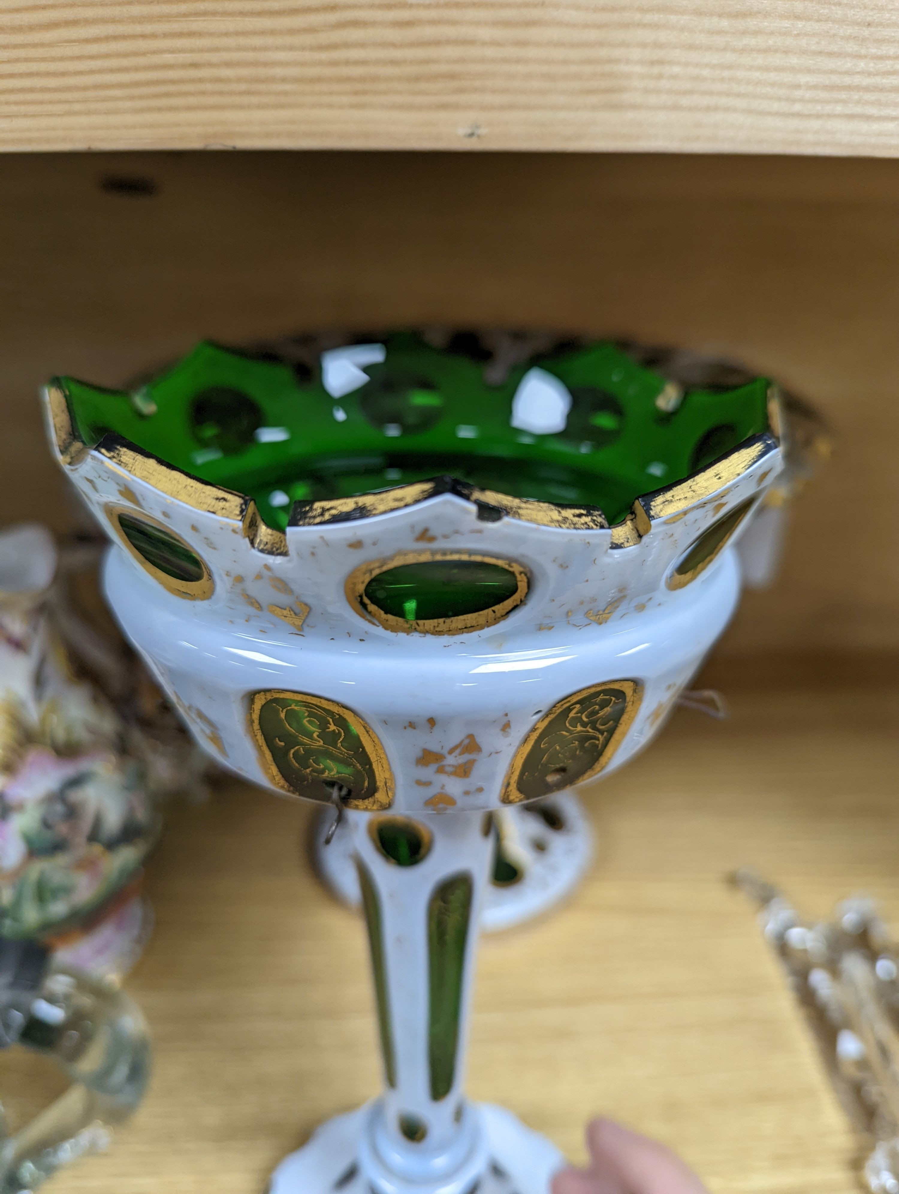 A 19th century overlaid green glass comport, 24cm high, and a similar table lustre